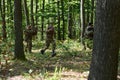 A specialized military antiterrorist unit conducts a covert operation in dense, hazardous woodland, demonstrating Royalty Free Stock Photo