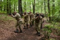 A specialized military antiterrorist unit conducts a covert operation in dense, hazardous woodland, demonstrating Royalty Free Stock Photo