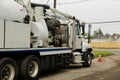 A specialized sewer cleaning machine works on a street