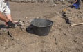 Specialized workers digging with trowel on archaeological excavation