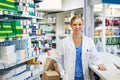 Specializing in your wellness. Portrait of a happy young woman working in a pharmacy.