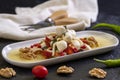 Specially prepared breakfast cheese. A special cheese plate prepared with olive oil, vegetables, walnuts and cheeses