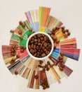 Specialty coffee concept. Roasted coffee beans in white cup on taster`s flavor wheel. Top view