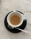 Cup of espresso black saucer marble like table