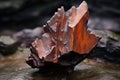a specimen of pitchblende on a rusted metal surface Royalty Free Stock Photo