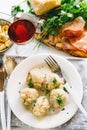 Dumplings cooked in broth on a laden table