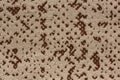 Speckled fabric background in light brown hue. Royalty Free Stock Photo