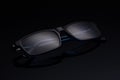 Classic glasses with diopters on a dark background with a soft glare.