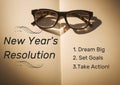 Spectacles on book with new year resolution goals Royalty Free Stock Photo