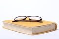 Spectacles lying on old book Royalty Free Stock Photo