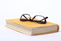 Spectacles lying on old book Royalty Free Stock Photo