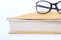 Spectacles lying on old book Royalty Free Stock Photo