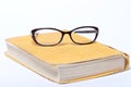 Spectacles lying on old book Royalty Free Stock Photo