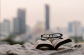 Spectacles and open book put on blanket in bedroom Royalty Free Stock Photo