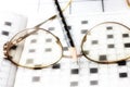 Spectacles, pencil, crossword Royalty Free Stock Photo