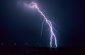 Long forked lightning bolt strikes down from a summer thunderstorm in Lake IJsselmeer, Netherlands