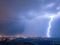 Spectacular, aerial shot of a city hit by multiple lightning. Dramatic, real drone shot of a massive storm over city. Royalty Free Stock Photo