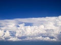 Spectacular aerial view from airplane window, beautiful, unique and picturesque white clouds with deep blue sky background