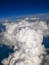 Spectacular aerial view from airplane window, beautiful, unique and picturesque white clouds with deep blue sky background