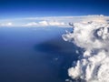 Spectacular aerial view from airplane window, beautiful, unique and picturesque white clouds with deep blue sky background