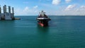 Spectacular aerial view of the bow of a container ship maneuvering upon arrival in port.