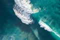 Spectacular aerial view of a surfer taking on waves in a blue ocean Royalty Free Stock Photo