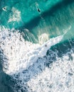 Spectacular aerial view of a surfer taking on waves in a blue ocean Royalty Free Stock Photo