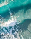 Spectacular aerial view of a surfer taking on waves in a blue ocean Royalty Free Stock Photo