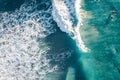 Spectacular aerial view of a surfer taking on waves in a blue ocean Royalty Free Stock Photo