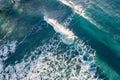 Spectacular aerial view of a surfer taking on waves in a blue ocean Royalty Free Stock Photo