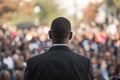 Spectacular afro american male politician speaks on stage in front of crowds