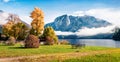 Spectacular autumn panorama of Altausseer See lake with Trisselwand peak on background. Impressive morning view of Altaussee