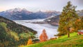 Spectacular autumn view of lake meadows trees and mountains in Sell Am See