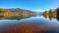 Spectacular autumn view of lake and trees in city park of Sell Am See