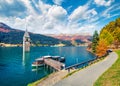 Spectacular autumn view of Tower of sunken church in Resia lake. Sunny morning scene of Italian Alps, South Tyrol, Italy, Europe.