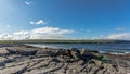 Spectacular bare limestone landscape and ocean in Doolin Bay with the Cliffs of Moher in the background Royalty Free Stock Photo