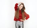 Spectacular blonde woman in red blouse silver leather pants posing in front of white wall. Graceful girl gorgeous long hair having