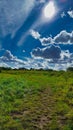 Spectacular blue sky with a green meadow in front