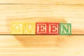 Spectacular colorful letters on wooden cubes on a wooden board with the word QUEEN Royalty Free Stock Photo