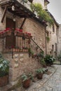 Spectacular colorful traditional italian medieval alley in the historic center of beautiful little town of Spello Perugia Royalty Free Stock Photo