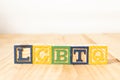 Spectacular colorful wooden cubes with the colors of the LGBTQ gay pride flag with the word LGBTQ