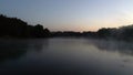 Aerial photography of the river at dawn. Rising mist from the river against the background of the rising sun