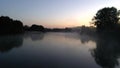 Aerial photography of the river at dawn. Rising mist from the river against the background of the rising sun