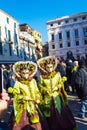 Spectacular disguised people Venice Masquerade and crowd of tourists Italy