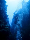 Silhouette of a scuba diver swimming out of the canyon divesite in Dahab, Egypt