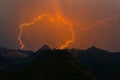 Spectacular double lightning bolt strike in mountain peak silhou Royalty Free Stock Photo