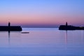 Spectacular early morning view of West and East Pier lighthouses of famous Dun Laoghaire harbor during the blue hour
