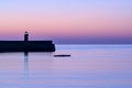 Spectacular early morning view of West Pier lighthouse of famous Dun Laoghaire harbor during the blue hour before sunrise, Dublin