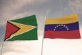 SPECTACULAR FLAGS OF GUYANA AND VENEZUELA WAVING WITH A BLUE SKY BACKGROUND CONFLICT RELTATIONSHIPS