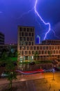 A spectacular lightning over an office bulding in a city at night.